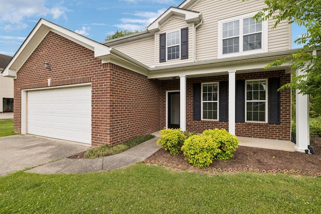 1000 Beverly Ln, Spring Hill, TN 37174 - traditional home with brick siding, asphalt driveway, covered porch, and an attached garage