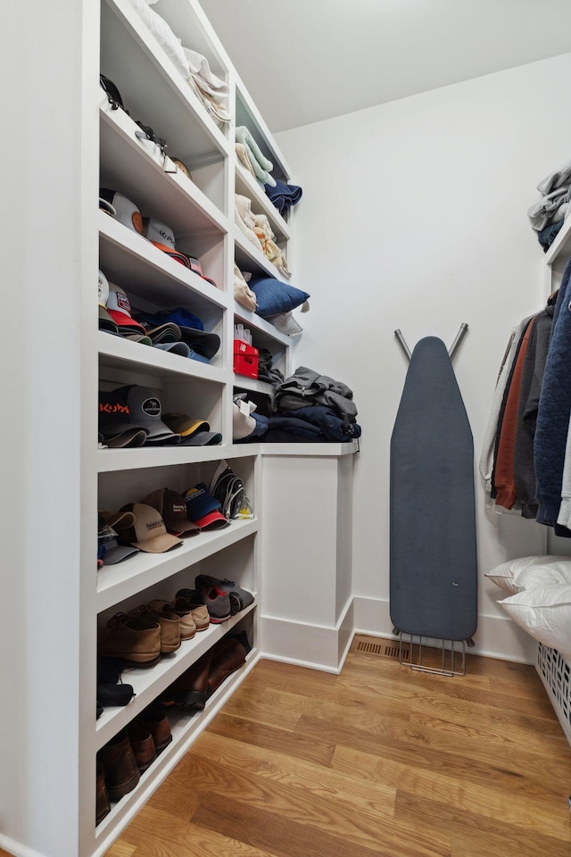 walk in closet featuring wood finished floors