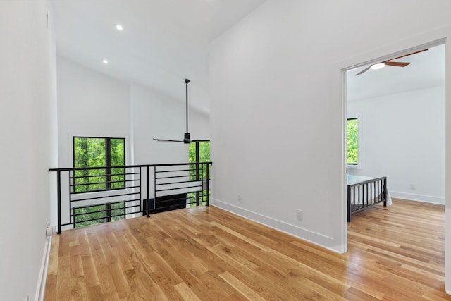 spare room with a ceiling fan, plenty of natural light, wood finished floors, high vaulted ceiling, and recessed lighting