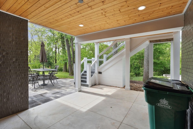 view of patio featuring outdoor dining space and stairway