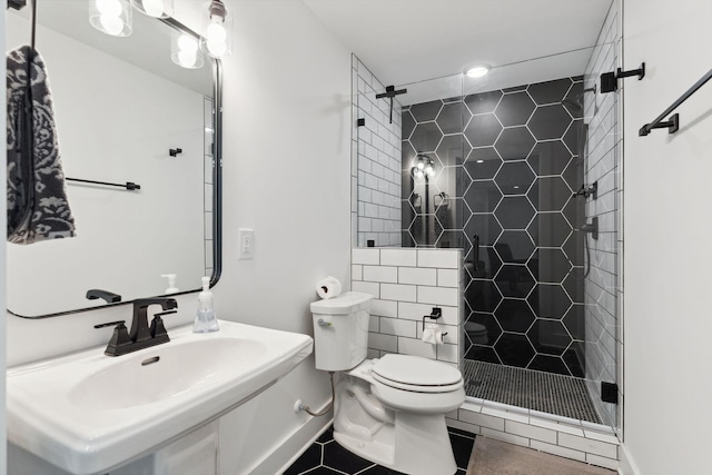 full bath with a shower stall, toilet, a sink, and baseboards