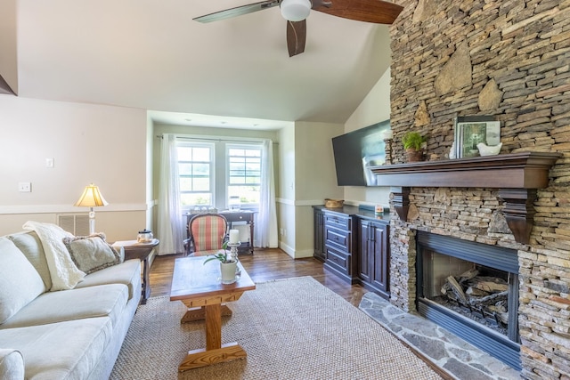 living area featuring a ceiling fan, dark wood-style floors, a fireplace, and high vaulted ceiling