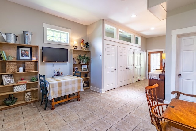 interior space featuring light tile patterned floors, recessed lighting, and baseboards