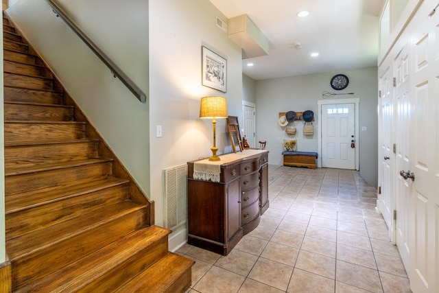 entryway featuring stairway, recessed lighting, and light tile patterned floors