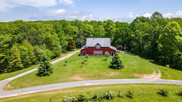 aerial view of property and surrounding area with a heavily wooded area