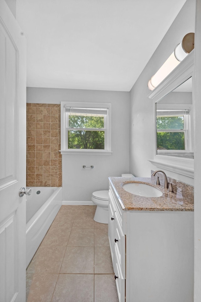 bathroom with plenty of natural light, tile patterned floors, toilet, and baseboards