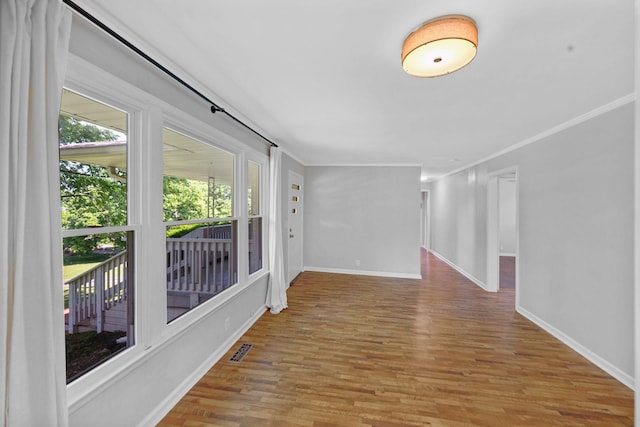 hall featuring wood finished floors and baseboards