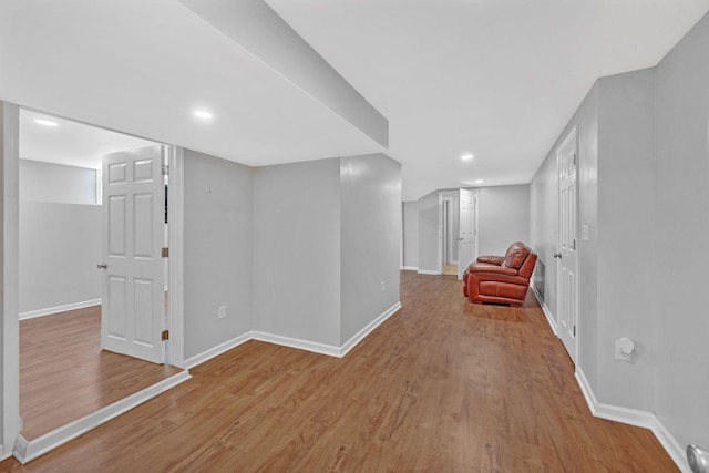 finished basement featuring wood finished floors, baseboards, and recessed lighting