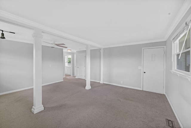 basement with carpet, ceiling fan, baseboards, and ornamental molding