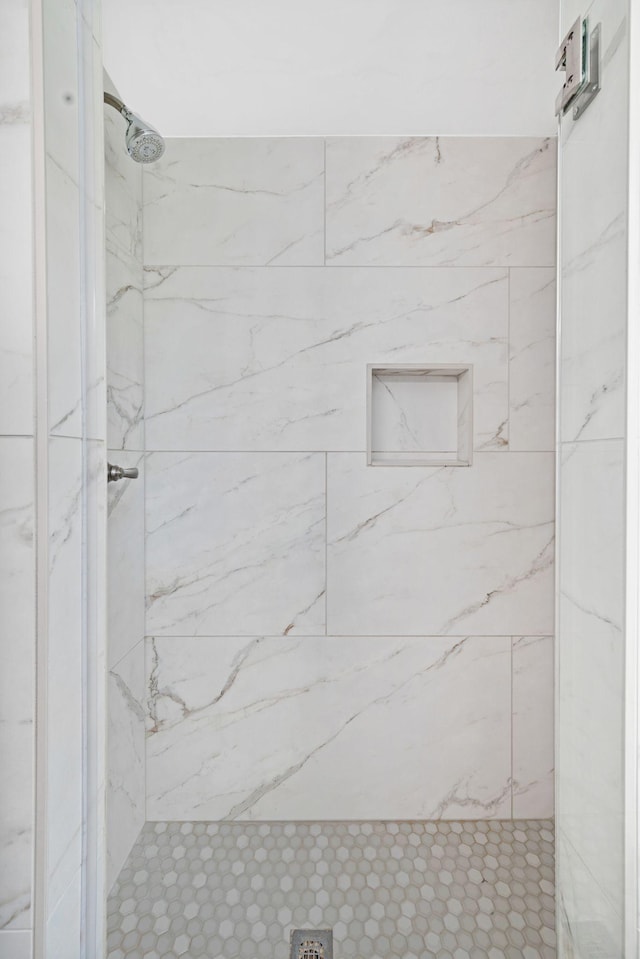 full bath featuring a marble finish shower