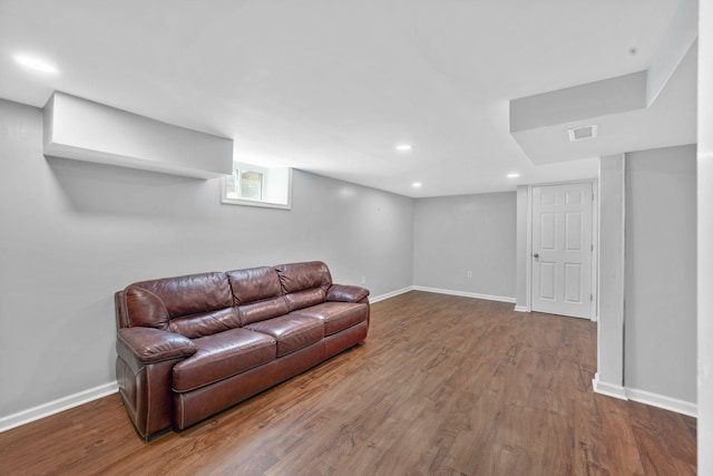 living area featuring wood finished floors, baseboards, and recessed lighting