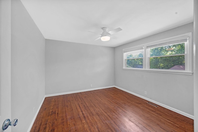 unfurnished room featuring wood finished floors, baseboards, and ceiling fan