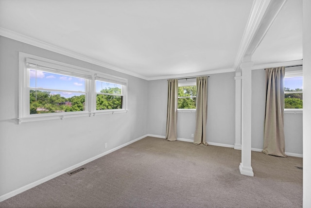 carpeted empty room featuring crown molding and baseboards