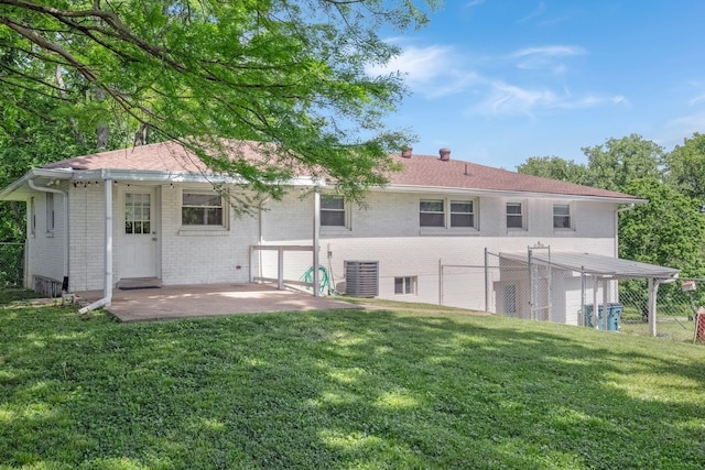 back of house with brick siding, a patio, central AC unit, and a chimney