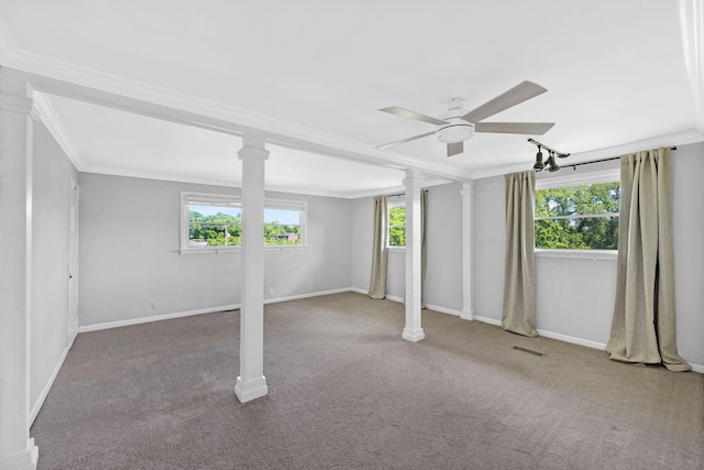 basement featuring ceiling fan, ornamental molding, healthy amount of natural light, carpet floors, and baseboards