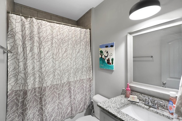 bathroom featuring vanity, toilet, and curtained shower