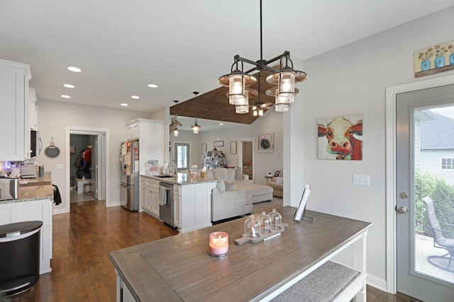 dining area featuring a chandelier, dark wood-style floors, recessed lighting, baseboards, and vaulted ceiling