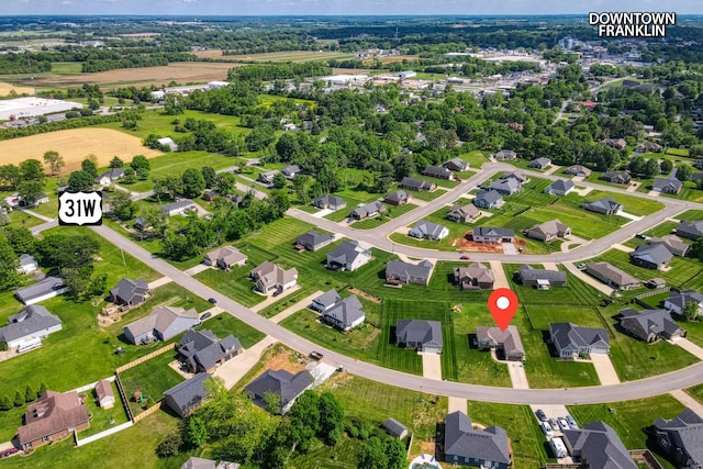 aerial view of property and surrounding area with nearby suburban area