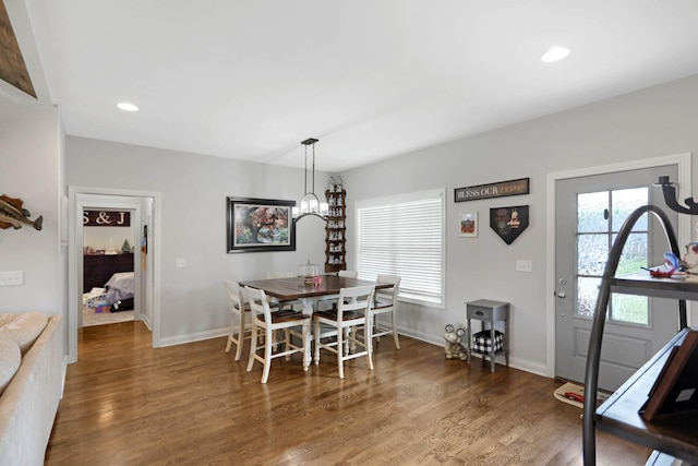 dining area with wood finished floors, baseboards, recessed lighting, and a chandelier