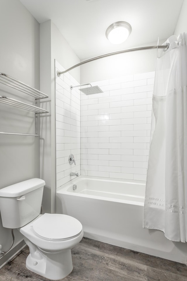 782 Riverfront Pkwy Unit 216, Chattanooga, TN 37402 - bathroom with wood finished floors, toilet, and shower / bath combo with shower curtain