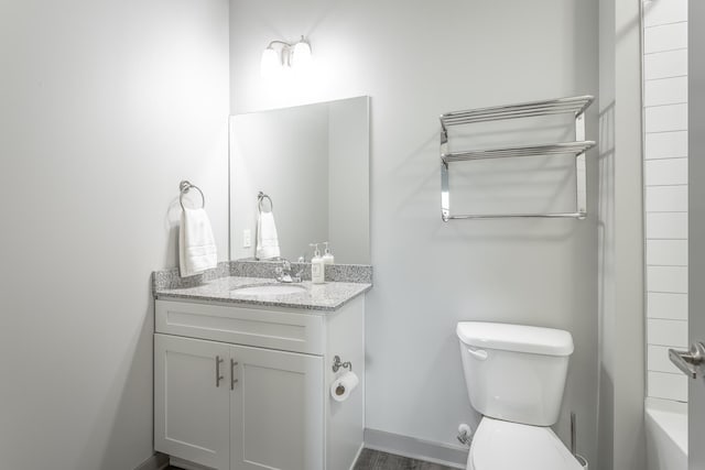 782 Riverfront Pkwy Unit 216, Chattanooga, TN 37402 - bathroom featuring toilet, vanity, a tub to relax in, baseboards, and a shower