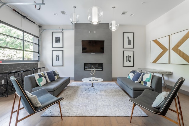 782 Riverfront Pkwy Unit 216, Chattanooga, TN 37402 - living room featuring hardwood / wood-style flooring, a fireplace, and recessed lighting