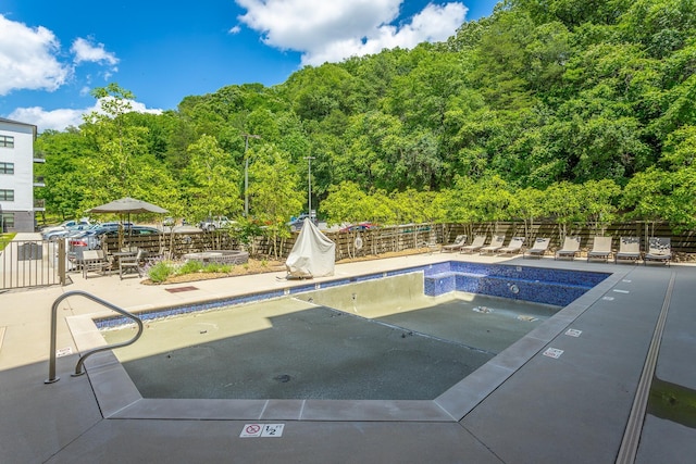 782 Riverfront Pkwy Unit 216, Chattanooga, TN 37402 - community pool featuring fence, a view of trees, and a patio