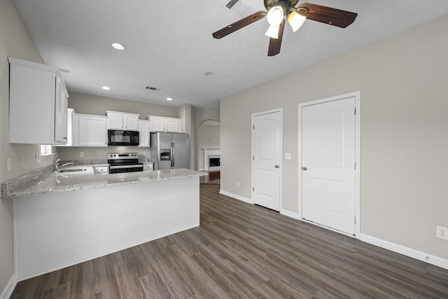 5029 Luker Ln, Antioch, TN 37013 - kitchen featuring stainless steel appliances, ceiling fan, dark wood finished floors, light stone counters, and recessed lighting