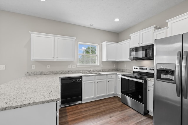 5029 Luker Ln, Antioch, TN 37013 - kitchen featuring black appliances, a sink, white cabinetry, recessed lighting, and a peninsula