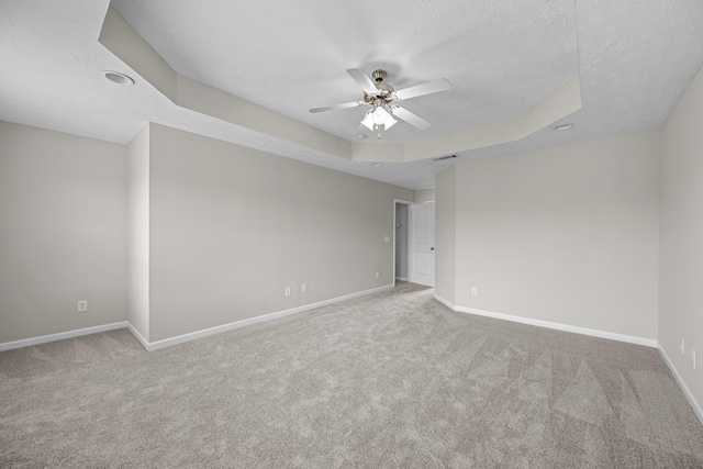 5029 Luker Ln, Antioch, TN 37013 - carpeted spare room with a ceiling fan, baseboards, a raised ceiling, and a textured ceiling