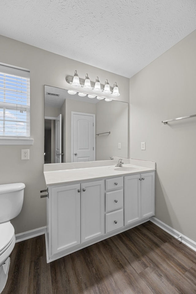 5029 Luker Ln, Antioch, TN 37013 - bathroom with toilet, wood finished floors, baseboards, vanity, and a textured ceiling