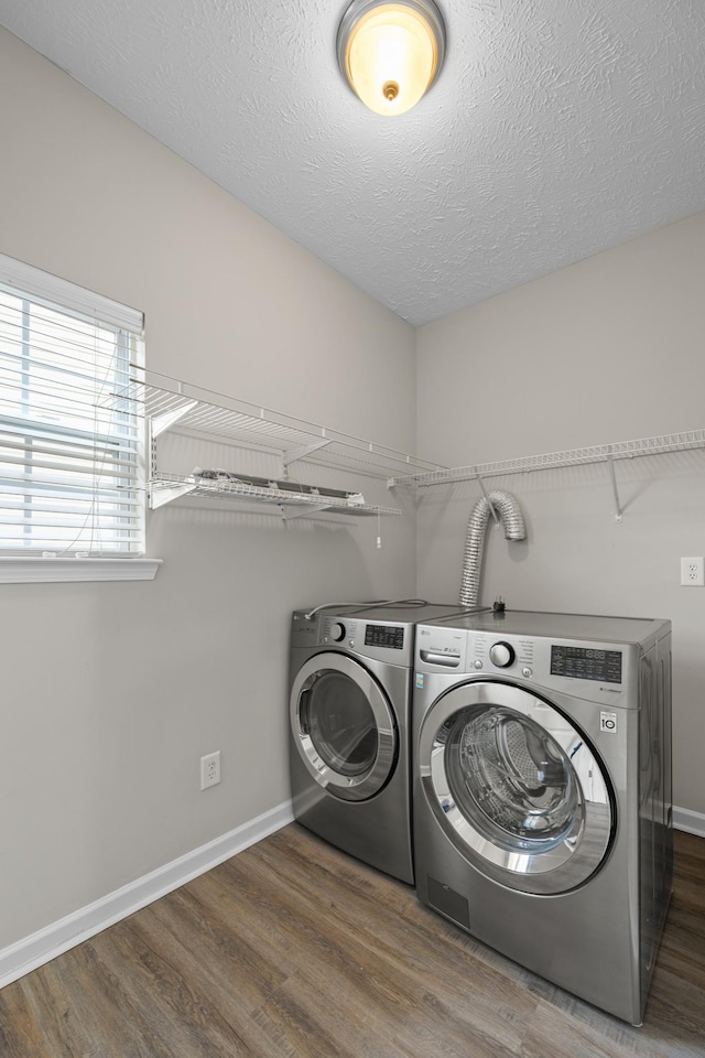 5029 Luker Ln, Antioch, TN 37013 - washroom featuring separate washer and dryer, wood finished floors, baseboards, and a textured ceiling