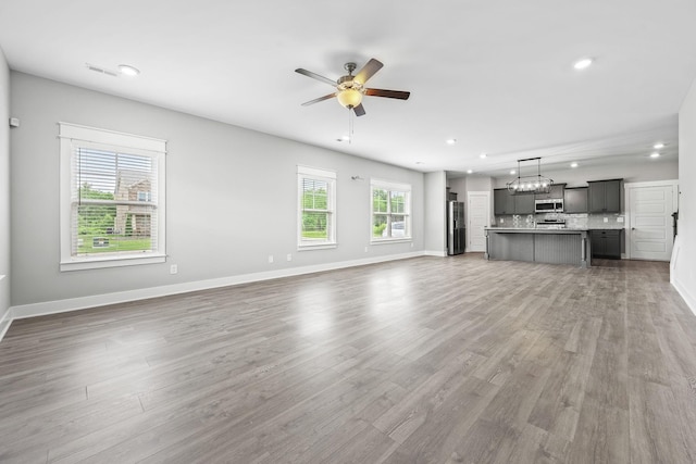 1132 General Marshall Ct, Murfreesboro, TN 37129 - unfurnished living room featuring wood finished floors, ceiling fan, recessed lighting, and baseboards
