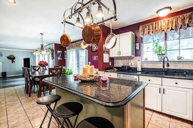 101 Wolverine Trl, La Vergne, TN 37086 - kitchen with a sink, healthy amount of natural light, light tile patterned flooring, white cabinetry, and crown molding