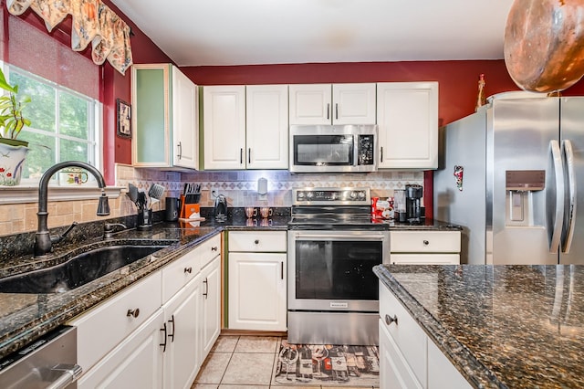101 Wolverine Trl, La Vergne, TN 37086 - kitchen with stainless steel appliances, white cabinets, a sink, and tasteful backsplash