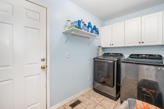 101 Wolverine Trl, La Vergne, TN 37086 - clothes washing area with cabinet space, washing machine and dryer, baseboards, and light tile patterned flooring