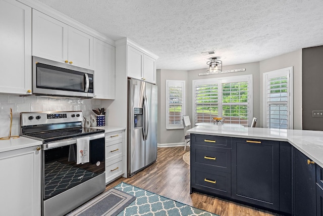 102 Braxton Park Ct, Goodlettsville, TN 37072 - kitchen featuring stainless steel appliances, light countertops, white cabinetry, dark wood-style flooring, and tasteful backsplash