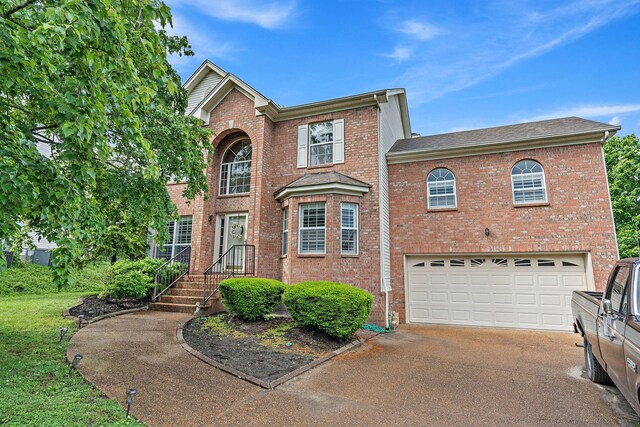102 Braxton Park Ct, Goodlettsville, TN 37072 - traditional-style house with driveway, brick siding, a garage, and roof with shingles