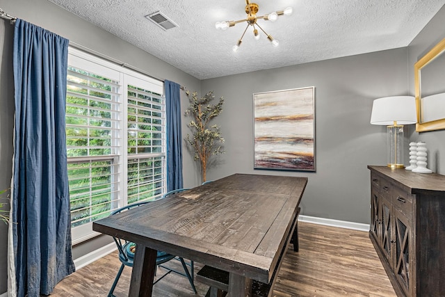 102 Braxton Park Ct, Goodlettsville, TN 37072 - dining space featuring a chandelier, wood finished floors, baseboards, and a textured ceiling