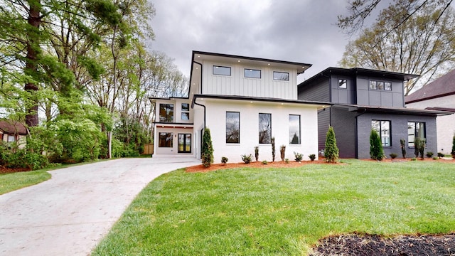 4026B Lealand Ln, Nashville, TN 37204 - view of front of house with driveway, a front yard, board and batten siding, brick siding, and french doors
