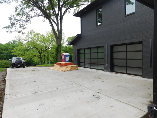4026B Lealand Ln, Nashville, TN 37204 - view of property exterior featuring an attached garage, driveway, and brick siding