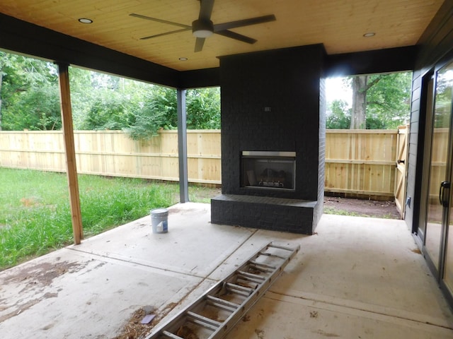4026B Lealand Ln, Nashville, TN 37204 - fenced backyard featuring an outdoor brick fireplace, a patio area, and ceiling fan