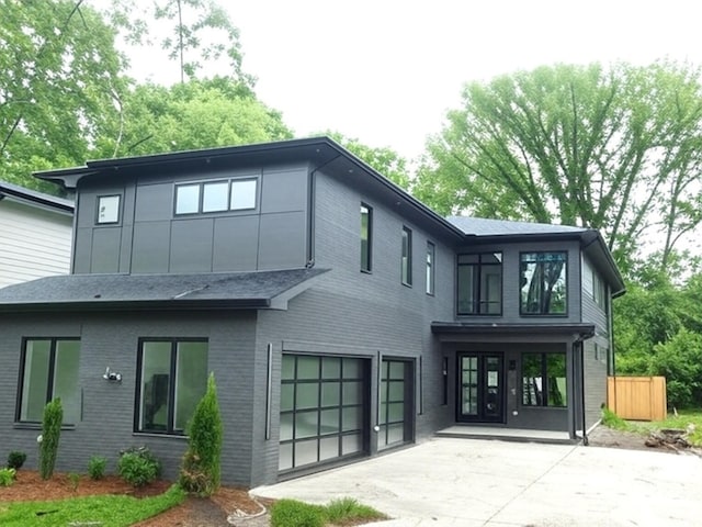 4026B Lealand Ln, Nashville, TN 37204 - back of house with an attached garage, driveway, brick siding, and a patio area