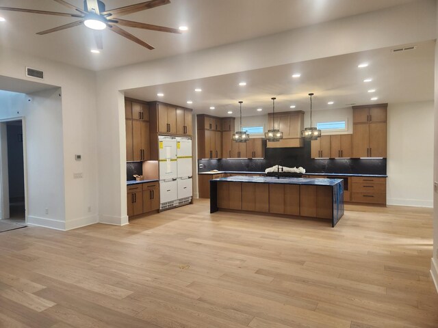4026B Lealand Ln, Nashville, TN 37204 - kitchen with light wood finished floors, a ceiling fan, brown cabinetry, backsplash, and recessed lighting
