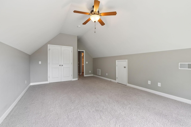 additional living space featuring lofted ceiling, baseboards, carpet, and ceiling fan