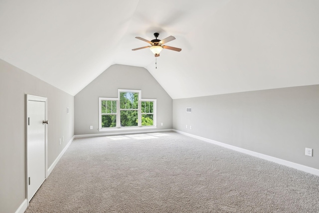 bonus room with vaulted ceiling, ceiling fan, carpet flooring, and baseboards