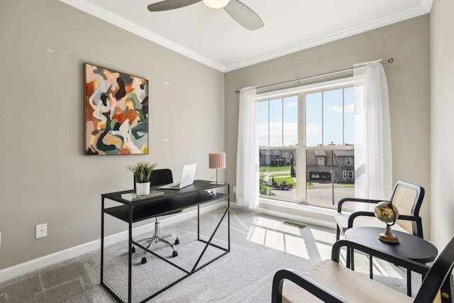 carpeted home office featuring crown molding, ceiling fan, and baseboards