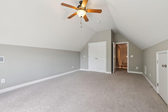 additional living space with carpet, lofted ceiling, ceiling fan, and baseboards