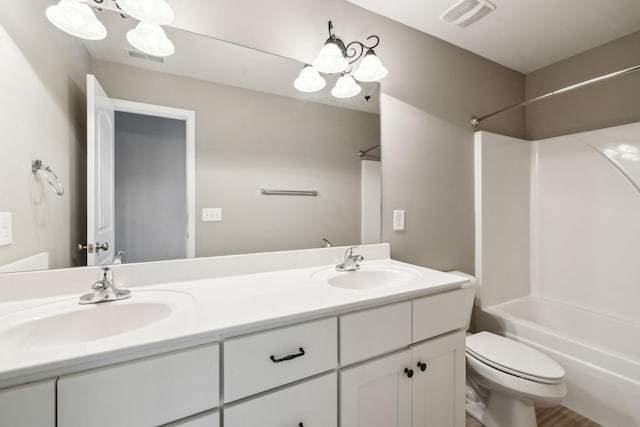 bathroom featuring toilet,  shower combination, and double vanity