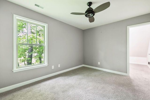spare room with healthy amount of natural light, carpet, a ceiling fan, and baseboards